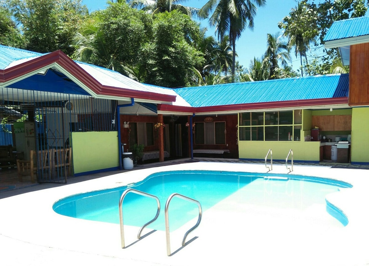 Property exterior with pool and covered walkways